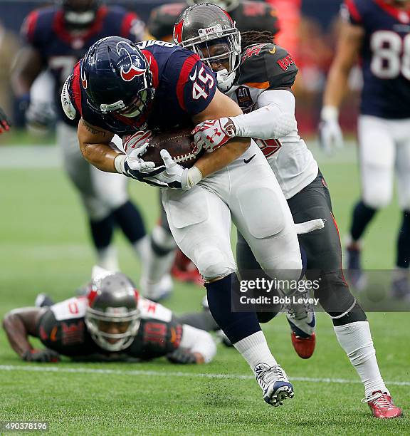 Jay Prosch of the Houston Texans is tackled by D.J. Swearinger of the Tampa Bay Buccaneers at NRG Stadium on September 27, 2015 in Houston, Texas.