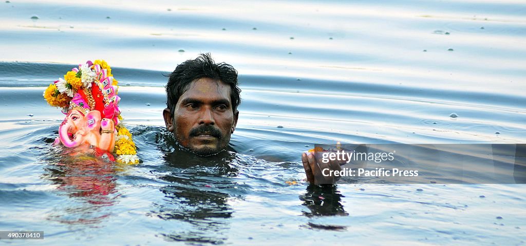 Indian devotee carries an idol of elephant-headed Hindu God...