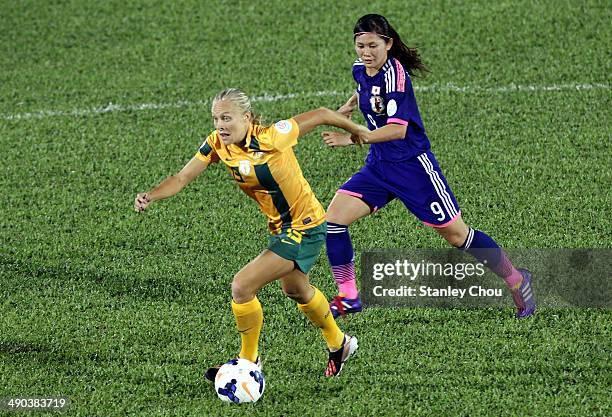 Tameka Butt of Australia is checked by Nahomi Kawasumi of Japan during the AFC Women's Asian Cup Group A match between Australia and Japan at Thong...