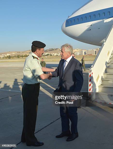 Secretary of Defense Chuck Hagel is welcomed by Jordan's Chairman of Defense Lieutenant General Mashal al-Zaben upon his arrival at Marka...