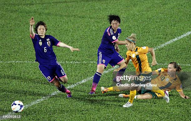 Katrina Gorry of Australia is checked by Nahomi Kawasumi and Megumi Kamionobe of Japan during the AFC Women's Asian Cup Group A match between...