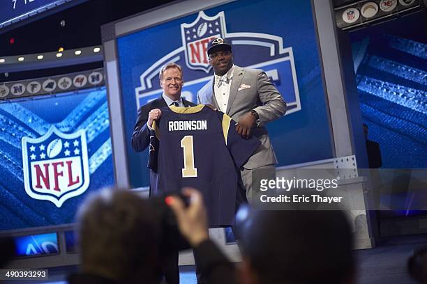 St. Louis Rams offensive tackle and No 2 overall pick Greg Robinson victorious on stage with NFL commissioner Roger Goodell during selection process...