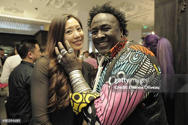 Senegalese jewelry designer 'Moko' posing with a guest during the Chrome Hearts Beijing Store Opening on May 14, 2014 in Beijing, China.