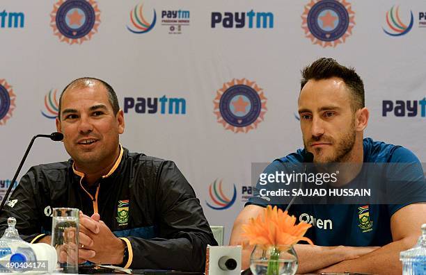 South African team coach Russell Domingo speaks as T20 captain Faf Du Plessis looks on during a press conference in New Delhi on September 28, 2015....