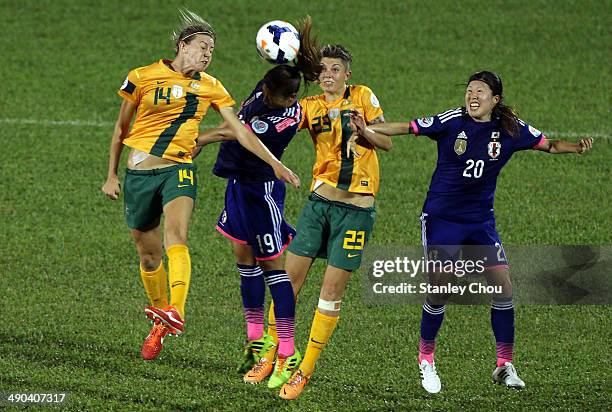 Rumi Utsugi#19 of Japan battles with Alanna Kennedy#14 and Michelle Heyman of Australia during the AFC Women's Asian Cup Group A match between...