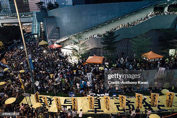 Pro-democracy protesters hold umbrellas and shout slogans during a rally outside of the Hong Kong Government Complex at Admiratly district on...