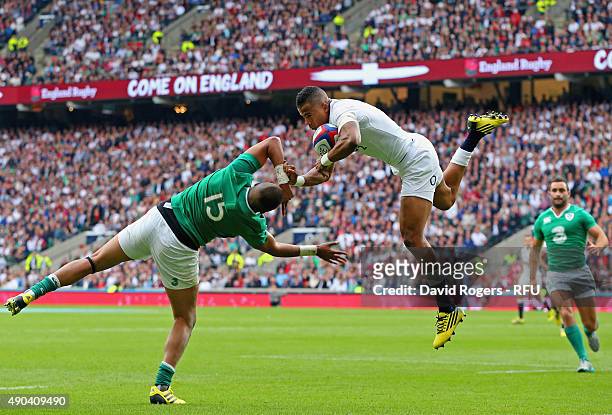 Anthony Watson of England takes the high ball over Simon Zebo of Ireland during the QBE International match between England and Ireland at Twickenham...