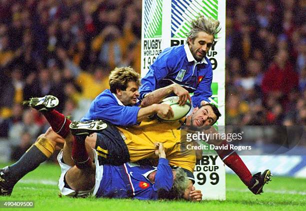 Nov 1999: Joe Roff of Australia is tackled short of the try line during the Final of the 1999 Rugby World Cup against France played at the Millennium...