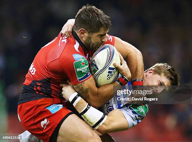 Sebastien Tillous-Borde of Toulon holds off the challenge from David Strettle of Saracens during the Heineken Cup Final between Toulon and Saracens...