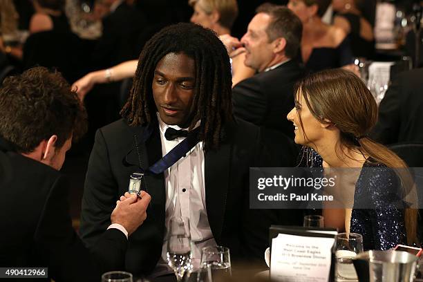 Luke Shuey looks at Nic Naitanui's Mark of the Year medal with Elle Demasi during the 2015 Brownlow Medal Function at Crown Perth on September 28,...