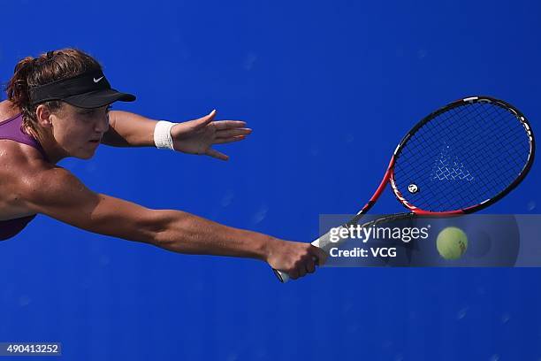 Patricia Maria Tig of Romania returns a shot against Kristina Mladenovic of France during day two of the 2015 Wuhan Open at Optics Vally...