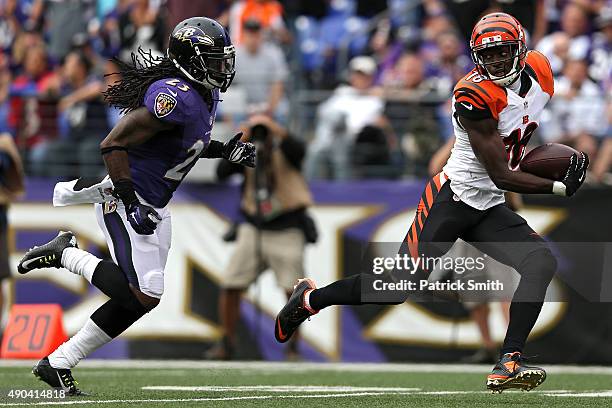 Wide receiver A.J. Green of the Cincinnati Bengals eludes free safety Kendrick Lewis of the Baltimore Ravens at M&T Bank Stadium on September 27,...