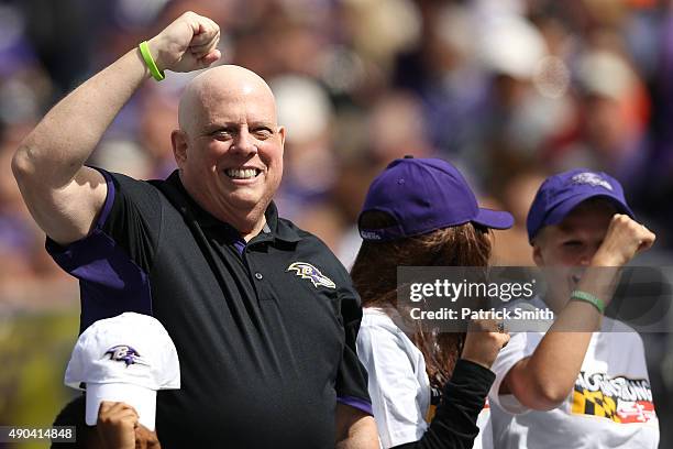 Maryland Gov. Larry Hogan acknowledges the crowd during a stop in play between the Baltimore Ravens and the Cincinnati Bengals at M&T Bank Stadium on...