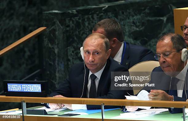 Russian President Vladimir Putin sits with the Russian Foreign Minister Sergey Lavrov at the United Nations General Assembly at U.N. Headquarters on...