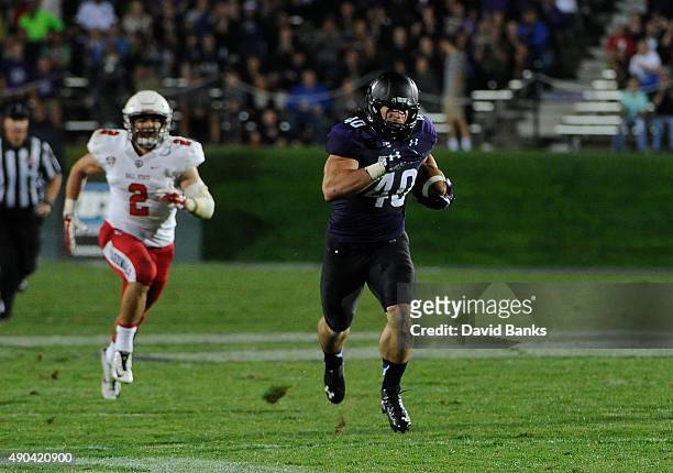 Dan Vitale fullback of the Northwestern Wildcats runs for a touchdown against the Ball State Cardinals during the first half on September 26, 2015 at...