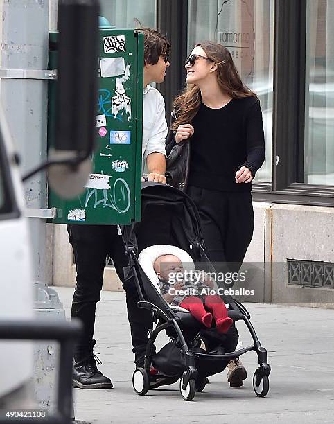 Actress Keira Knightley and her musician husband James Righton stroll with their baby Edie Righton in Soho on September 28, 2015 in New York City.