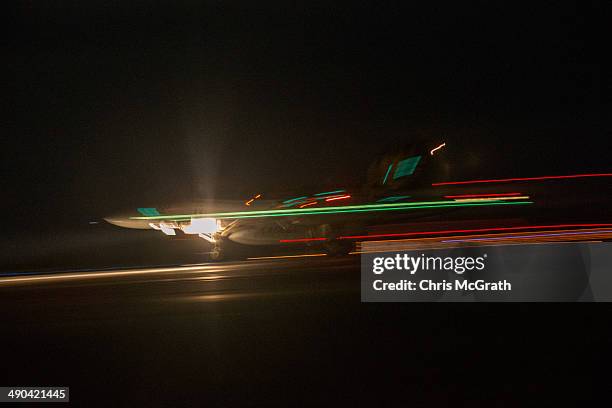 Pilots in a F/A-18E Super Hornet complete a night time, touch-and-go landing during Field Carrier Landing Practice for the Carrier Air Wing 5 of U.S....