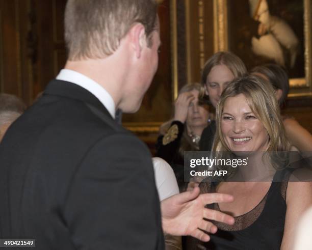 Britain's Prince William, Duke of Cambridge, speaks with model Kate Moss during a reception celebrating the work of The Royal Marsden hosted at...