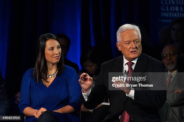 Barclay's Chairman John McFarlane, right, talks while UNICEF's Senior Advisor on Innovation to the Executive Director Erica Kochi, left, listens...