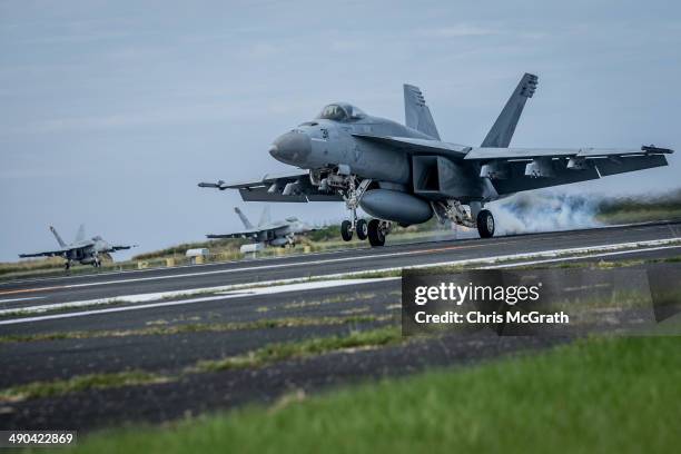 Pilot in a F/A-18E Super Hornet completes a touch-and-go landing during Field Carrier Landing Practice for the Carrier Air Wing 5 of U.S. Naval Air...