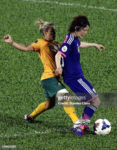 Mizuho Sakaguchi of Japan is tackled by Katrina Gorry of Australia during the AFC Women's Asian Cup Group A match between Australia and Japan at...