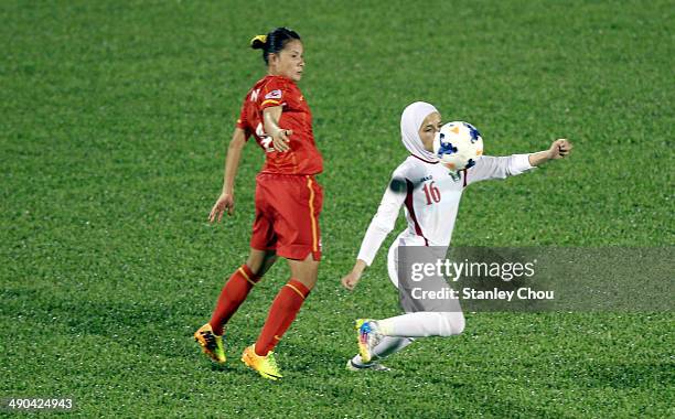 Shahnaz Yaseen of Jordan is checked by Shahnaz Yaseenof Vietnam during the AFC Women's Asian Cup Group A match between Vietnam and Jordan at Thong...