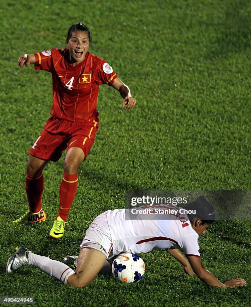 Nguyen Thi Nga of Vietnam tackles Maysa Ziad of Jordan during the AFC Women's Asian Cup Group A match between Vietnam and Jordan at Thong Nhat...