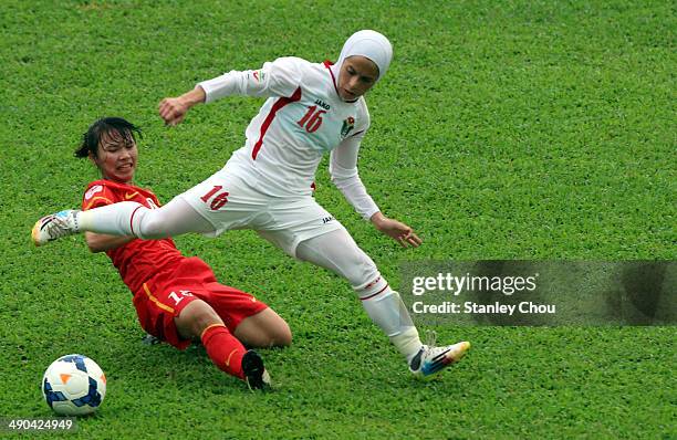 Shahnaz Yaseen of Jordan is checked by Nguyen Thi Lieu of Vietnam during the AFC Women's Asian Cup Group A match between Vietnam and Jordan at Thong...