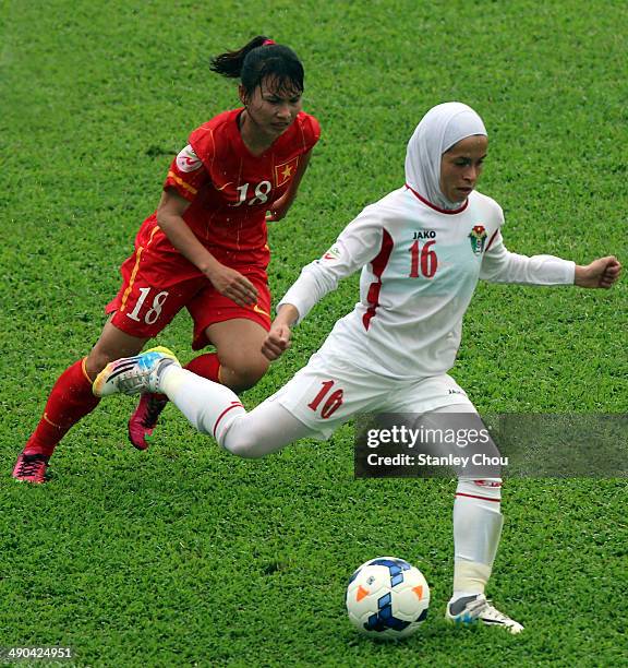 Shahnaz Yaseen of Jordan is checked by Nguyen Thi Lieu of Vietnam during the AFC Women's Asian Cup Group A match between Vietnam and Jordan at Thong...