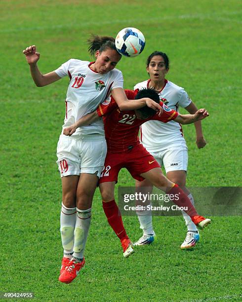 Aya Faisal of Jordan is tackled by Le Thu Thanh Huong of Vietnam during the AFC Women's Asian Cup Group A match between Vietnam and Jordan at Thong...