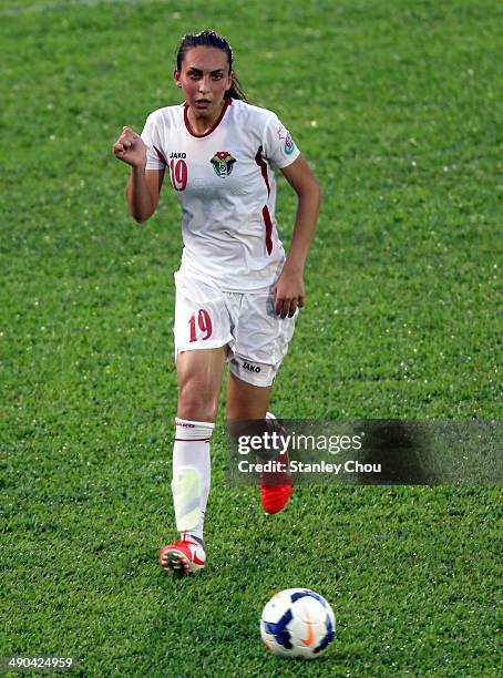 Aya Faisal of Jordan runs with the ball during the AFC Women's Asian Cup Group A match between Vietnam and Jordan at Thong Nhat Stadium on May 14,...
