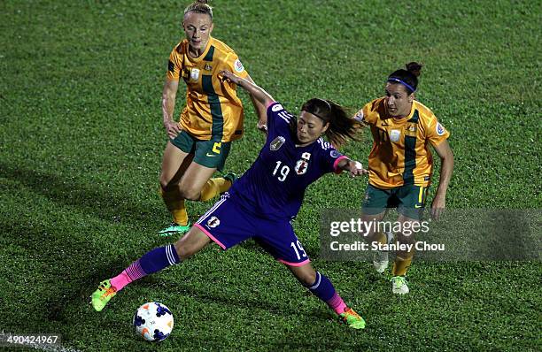 Rumi Utsugi of Japan evades a challenge by Teigen Allen and Lydia Williams of Australia during the AFC Women's Asian Cup Group A match between...