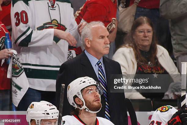 Chicago Blackhawks Head Coach Joel Quenneville watches from behind the bench against the Minnesota Wild during Game Four of the Second Round of the...