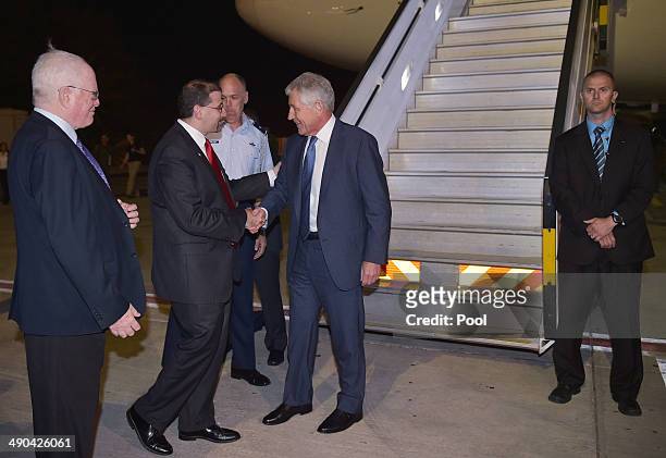 Defense Secretary Chuck Hagel shakes hands with U.S. Ambassador to Israel Dan Shapiro upon arrival at Ben Gurion International Airport on May 14,...