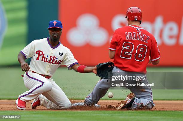 Jimmy Rollins of the Philadelphia Phillies is unable to catch the ball on a successful steal by Raul Ibanez of the Los Angeles Angels in the first...