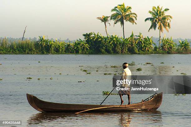 kerala, india: fisherman and canoe at dawn in kerala backwaters - malabar_coast stock pictures, royalty-free photos & images