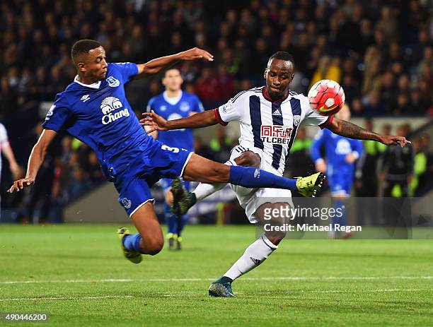 Saido Berahino of West Bromwich Albion is challenged by Brendan Galloway of Everton during the Barclays Premier League match between West Bromwich...