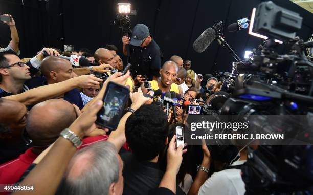 Kobe Bryant of the Los Angeles Lakers is surrounded by the press during the Los Angeles Lakers media day on September 28, 2015 in El Segundo,...