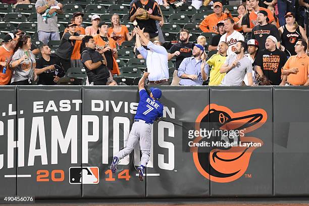 Ben Revere of the Toronto Blue Jays is not able to reach a ball off the bat of Ryan Flaherty of the Baltimore Orioles that went for a three-run home...