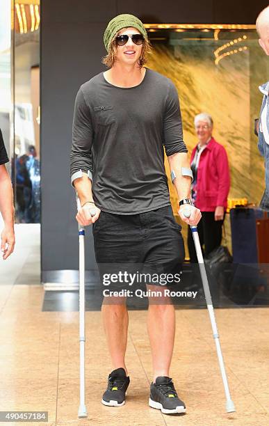 Brownlow Medal winner Nat Fyfe of the Dockers arrives at the press conference on crutches during a media opportunity at Crown Entertainment Complex...
