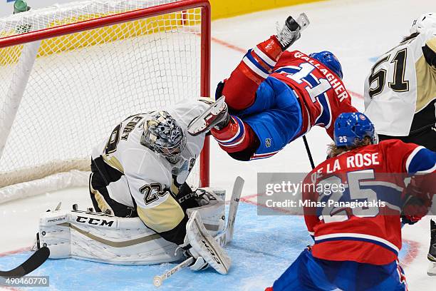 Brendan Gallagher of the Montreal Canadiens jumps over goaltender Marc-Andre Fleury of the Pittsburgh Penguins during a NHL pre-season game at the...