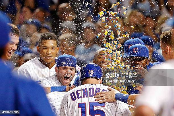 The Chicago Cubs celebrate a walkoff home run by Chris Denorfia of the Chicago Cubs against the Kansas City Royals at Wrigley Field on September 28,...