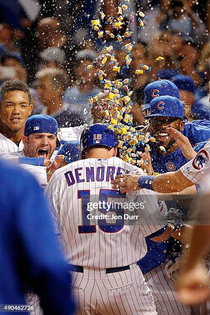 The Chicago Cubs celebrate a walk-off home run by Chris Denorfia of the Chicago Cubs against the Kansas City Royals at Wrigley Field on September 28,...