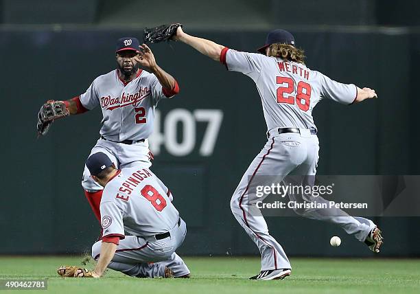 Outfielders Denard Span, Danny Espinosa and Jayson Werth of the Washington Nationals come together as they are unable to catch a ball hit by Martin...