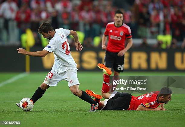 Coke of Sevilla turns away from Guilherme Siqueira of Benfica during the UEFA Europa League Final match between Sevilla FC and SL Benfica at Juventus...