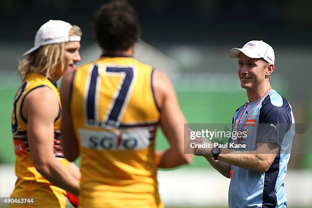 Adam Selwood assistant coach of the Eagles talks with Josh Kennedy and Tom Lamb during a West Coast Eagles AFL training session at Domain Stadium on...