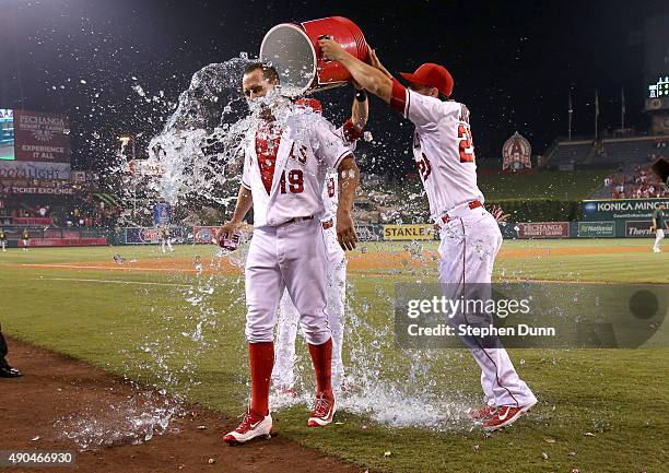 David Murphy of the Los Angeles Angels of Anaheim is doused by Matt Joyce and Taylor Featherston after his walk off RBI single in the ninth inning...