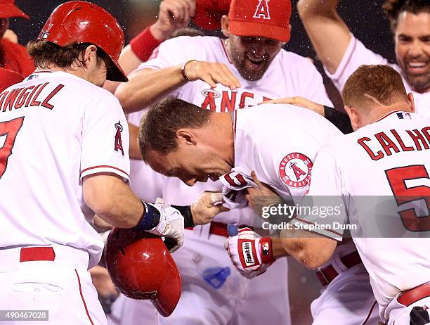 David Murphy of the Los Angeles Angels of Anaheim is mobbed by teammates after his walk off RBI single in the ninth inning against the Oakland...