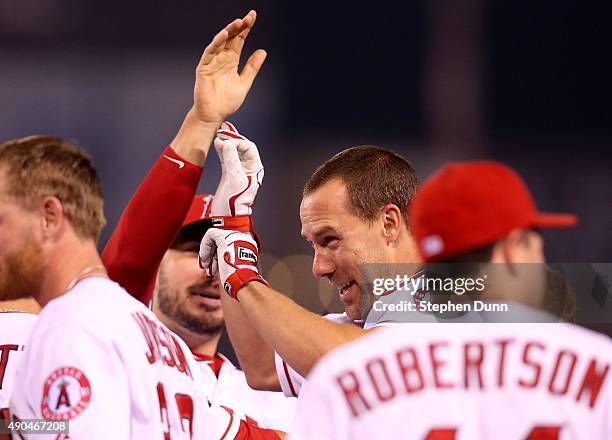 David Murphy of the Los Angeles Angels of Anaheim is mobbed by teammates after his walk off RBI single in the ninth inning against the Oakland...