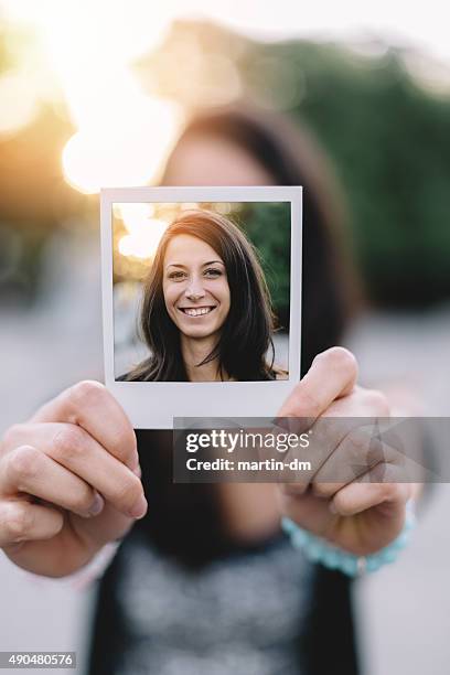 girl holding instant photo selfie - polaroid frame hand stock pictures, royalty-free photos & images